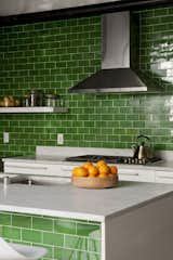 Kitchen, Subway Tile Backsplashe, Marble Counter, and White Cabinet Stem green subway tiles, crisp against white marble countertops, unite this kitchen's island and galley counter.  Photos from How the Colors in Your Kitchen Affect Your Appetite