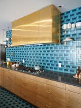 This kitchen, from the 2015 Sunset Idea House, features a pattern of blue &amp; turquoise tiles from the back wall all the way to the kitchen floor. &nbsp;