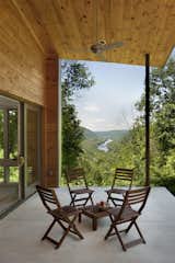 More public spaces in the house, like this open porch, were carefully sited to frame impressive views of the river and capture both sunlight and shade.