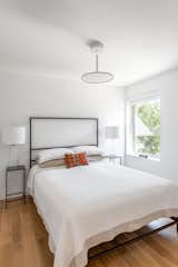 Bedroom, Ceiling, Table, Night Stands, Bed, Light Hardwood, and Pendant Guest Bedroom  Bedroom Table Bed Ceiling Light Hardwood Photos from Spa Creek House