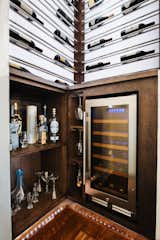Wine bar design accommodates liquor and stemware storage.