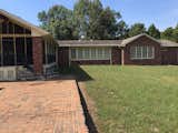 The back of house prior to renovations. It had a great screened porch and beautiful windows, but unfortunately, they were wood/old/rotting. They had to be replaced and the brick was painted. 