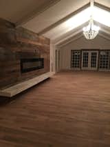 The new wall in master bedroom. We added the barn wood fireplace with marble ledge and changed the routing into the master closet.