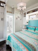 The bathroom is unconventional in that there is a private toilet and tub, but the vanity is in open space. Shown here is a queen size bed.