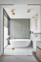 In the principal ensuite, glass doors lead into a wet area for shower and bath.