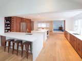 contrasting high gloss quartz counters with reclaimed American redwood cabinet fronts