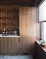 Kitchen, Wood Cabinet, Concrete Floor, Granite Counter, Ceramic Tile Backsplashe, Accent Lighting, Drop In Sink, and Refrigerator  Photo 5 of 22 in Mulherin's Hotel by Daniel Olsovsky