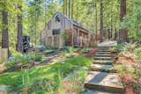 The property also features lushly landscaped areas with paths for walking through the enchanted setting. The two-car garage is designed in the same Sea Ranch style.