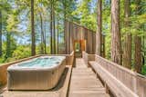 In 2010, an addition was added onto the rear of the home, accessible via a catwalk that appears to float among the redwood trees. A hot tub rounds out the options for relaxing and entertaining in this lush oasis.