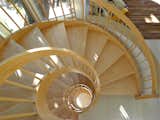 The custom maple staircase creates a nautilus spanning the four stories of the home.