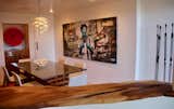 Dining Room, Table, Chair, Pendant Lighting, and Light Hardwood Floor The handcrafted acacia bar has a great view of Air City by Eddie Colla while African water-diviners look on.  Photo 6 of 10 in City Treehouse by Mindy Ross