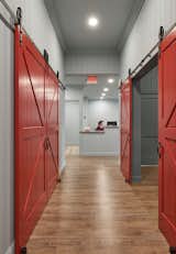 Bright red barn doors and soft hues of bead board lend a residential ambience to this VNA home.