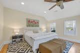 Bedroom, Bench, Ceiling Lighting, Bed, Night Stands, and Medium Hardwood Floor Primary bedroom.  Photo 15 of 15 in Tavern House by Debra LaPorte Communications