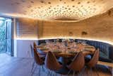 Dining Room, Ceiling Lighting, Medium Hardwood Floor, Wall Lighting, Chair, and Table The dinning room gives access to a balcony that provides natural air circulation.  Photo 4 of 13 in Photocatalytic Cave MM by Amezcua