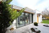 Outdoor, Boulders, Small Patio, Porch, Deck, and Front Yard The existing courtyard was transformed into the living room  Photo 12 of 13 in Extension of a house in Geneva by KELLER ARCHITECTES