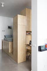 Bedroom, Bed, Bookcase, Concrete Floor, Night Stands, Ceiling Lighting, and Wardrobe The night space nestles discreetly in a piece of furniture concealing closet and desk.  Photo 6 of 17 in Hauteville street residence by Julebourg