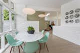 Dining Room, Chair, Table, Pendant Lighting, Medium Hardwood Floor, and Wood Burning Fireplace  Photos from Winning Design | Edward H. Fickett, F.A.I.A | Mid-Century Modern | Encino, CA