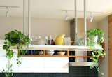 Kitchen, Ceiling Lighting, White Cabinet, Range Hood, Recessed Lighting, Ceramic Tile Backsplashe, and Track Lighting East Williamsburg Townhouse Renovation by New York Architect Adi Gershoni  Photos from East Williamsburg Townhouse