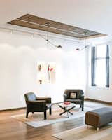 Living Room, Pendant Lighting, Arm Chairs, Ottomans, Ceiling Lighting, Wall Lighting, Dark Hardwood Floors, Coffee Table