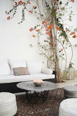 Moroccan rugs, leather poufs and hand hammered silver tables make stark spaces comfortable.  Photo 7 of 10 in 10 Ways to Use Rugs in Your Outdoor Space This Spring