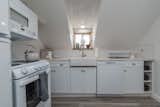 Kitchen, Subway Tile Backsplashe, Microwave, Refrigerator, Range, Wood Counter, Medium Hardwood Floor, and Wood Cabinet After Kitchen  Photo 1 of 10 in Carriage on Capital by Toni