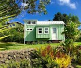 This custom-built hut by Habitats Hawaii can sleep five people. There’s a single bench/bed in the kitchen and a window bump-out bed with a double punee’ downstairs. The loft-style main bedroom displays queen bed. 