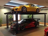 Garage Add an extra Porsche with a custom residential car lift by American Custom Lifts, designers of the first and only American-made single post car lift for storing two vehicles in the parking space of one.  Photos from 9 Prefab Garage Solutions for Auto Enthusiasts