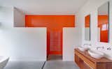 A bold color simply on one wall makes the difference in brightening this otherwise blank space.  Photo 1 of 11 in These 10 Designers Are Experts at Creating Colorful Bathrooms That Pop
