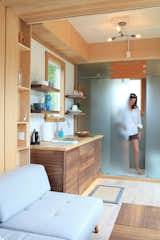 Behind a half-inch of sliding frosted glass sits The Sturgis's spa-like bathroom, with a Kohler toilet, Blendart ceramic tile and an indoor/outdoor rainshower.
