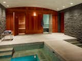 Blue tiles and elements of stone create a beautiful contrast against the warmth of the redwood features in this luxury spa. Image credit: Aleck Wilson Architects 