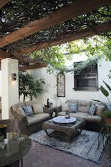 The entire courtyard is shaded by the massive redwood timber pergola and the 60-year old trumpet vines. Decorated with several seating areas and plush furnishings, the space is nothing short of idyllic. 