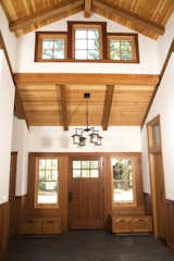 The home features a custom entry door made of natural Redwood. In addition, the wainscoting throughout the home is Redwood as well. 