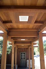 A covered breezeway seamlessly connects the home with the garage. Redwood timber posts were used for the support members for their beauty, durability, and strength.