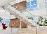 The spectacular marble floating stairwell, with glass balustrade and steel railing, features individual steps illuminated from within. It lends a sense of glamour and fantasy that literally transports clients to another level.
