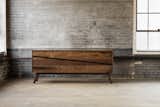 Made from solid walnut, the Samson Credenza features a customizable interior, and a recessed slanting dovetail finger pull