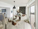 Airy one room living/dining, with multiple sliding doors opening to a deck.