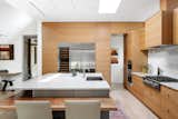 View of Kitchen with Pantry to the Right Beyond: The Kitchen Features an array of Demure Material Finishes. 