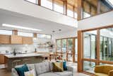 View of Kitchen and Dining Spaces from Living Room: Lofty Ceilings, Plentiful Sunlight, Warm and Varied Finishes make this Contemporary Home Feel Inviting, Comfortable and Luxurious.