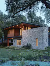 Oblique view to front facade at dusk