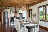 The kitchen and dining room flow directly from the open living room... the views continue as well.  Photo 6 of 14 in Timber Frame Barn Home in a Hayfield by OakBridge Timber Framing