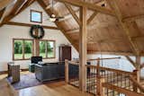This side of the loft often serves as movie room.   Photo 10 of 14 in Timber Frame Barn Home in a Hayfield by OakBridge Timber Framing