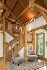 Handcarved stairs lead to the loft space, which can serve as an exercise space, guest space, or additional entertainment room.