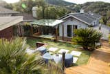 Every inch of the backyard is put into use with a well planned and thought through design. Due to the steep backyard topography I-beam steel reinforced retaining walls are integrated as a design element. In order to maximize the use of space, the backyard is terraced into three levels each of which has a separate use and function.