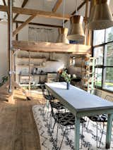 Dining Area with Antique Zinc-Topped Table, Metal Chairs, Industrial Bakery Cart + Spun Aluminum Mid Century Pendant Lights