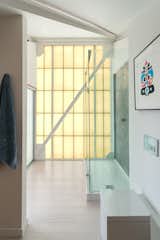 One of the home’s three bathrooms is fitted with an oversized glass shower.