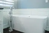 A simple soaking tub looks refined and takes up much less space than the previous sunken corner tub.