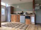 Kitchen area, made with reclaimed wood from several sources among the 84% reclaimed materials used throughout.  The MVHR pump is lower right and the solar system controls have been left exposed top right. 
