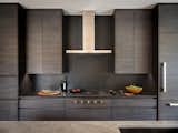 Fulfilling all of our moody kitchen dreams with this stunner showcasing custom oak millwork. We softened the look with a hand made backsplash and wood accents.