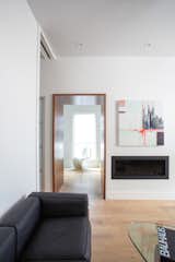 View of living room looking through walnut portal to entry/stair