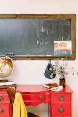 A vintage red desk makes for the perfect perch to pay bills or for arts and crafts with the kids.